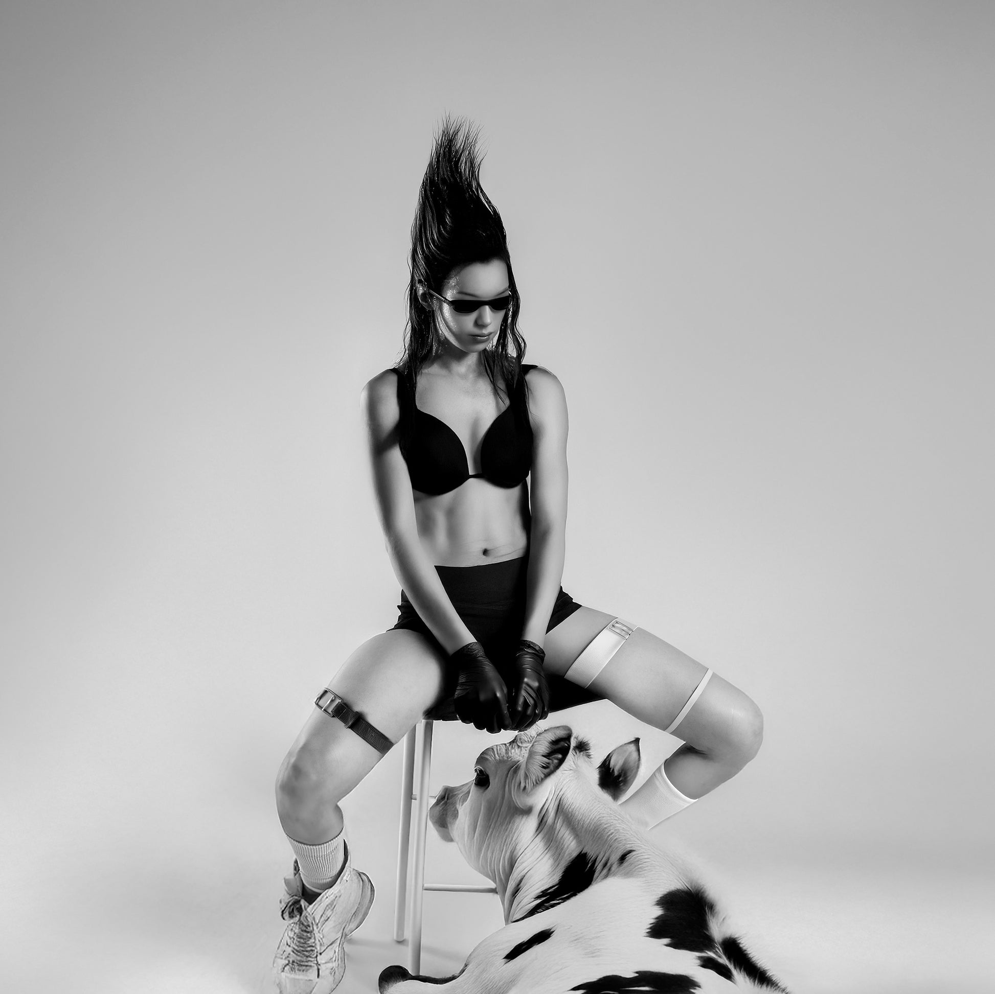 Homies by Erin Naifeh - bold black and white photography of figure with mohawk sitting beside cow in coordinated black and white styling